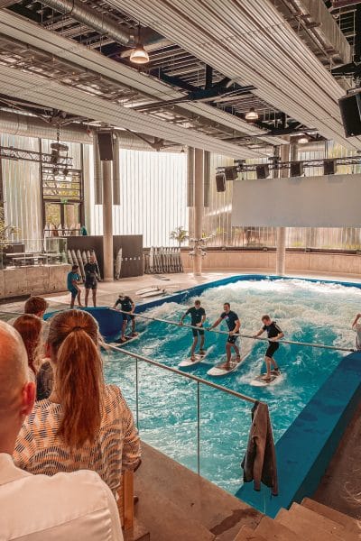 Vier Einsteiger surfen mit Haltestange in der Jochen Schweizer Arena